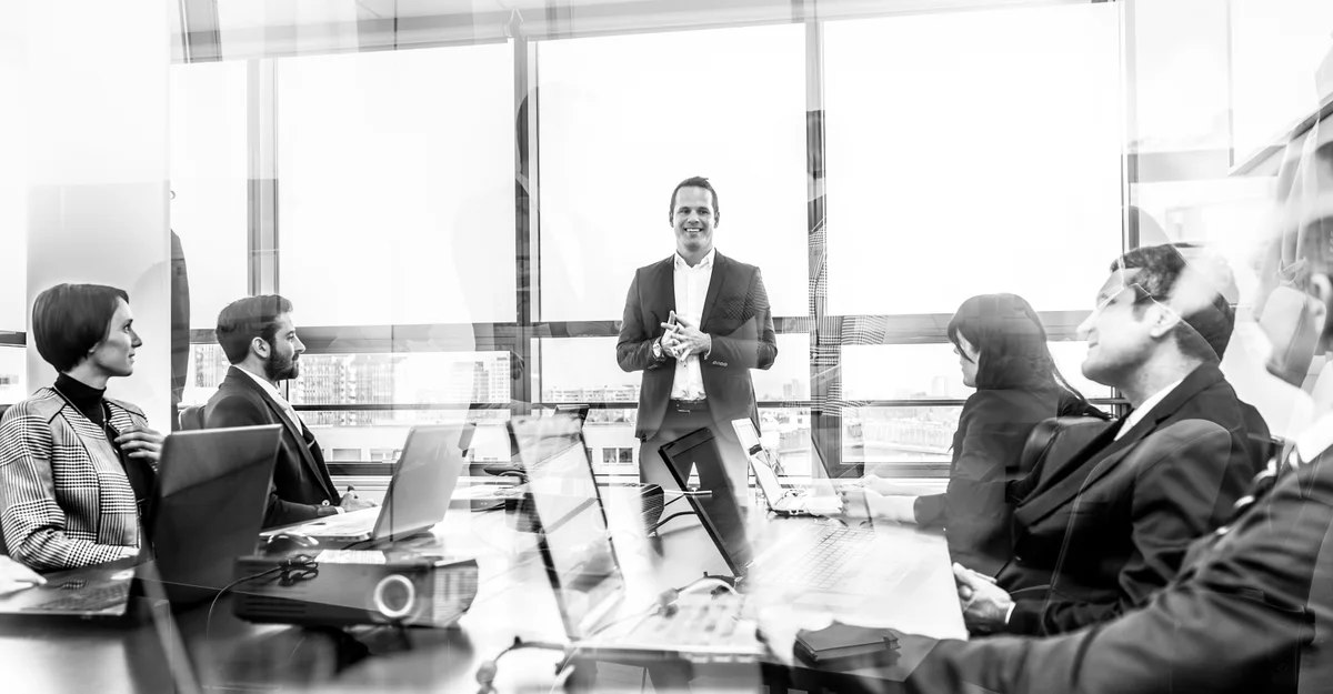 A leadership team in discussion around a boardroom table